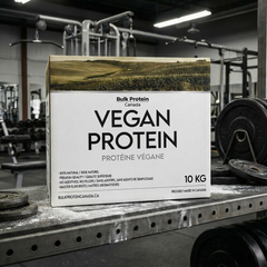 Box of Bulk Protein Canada Vegan Protein on a gym bench with gym equipment in the background